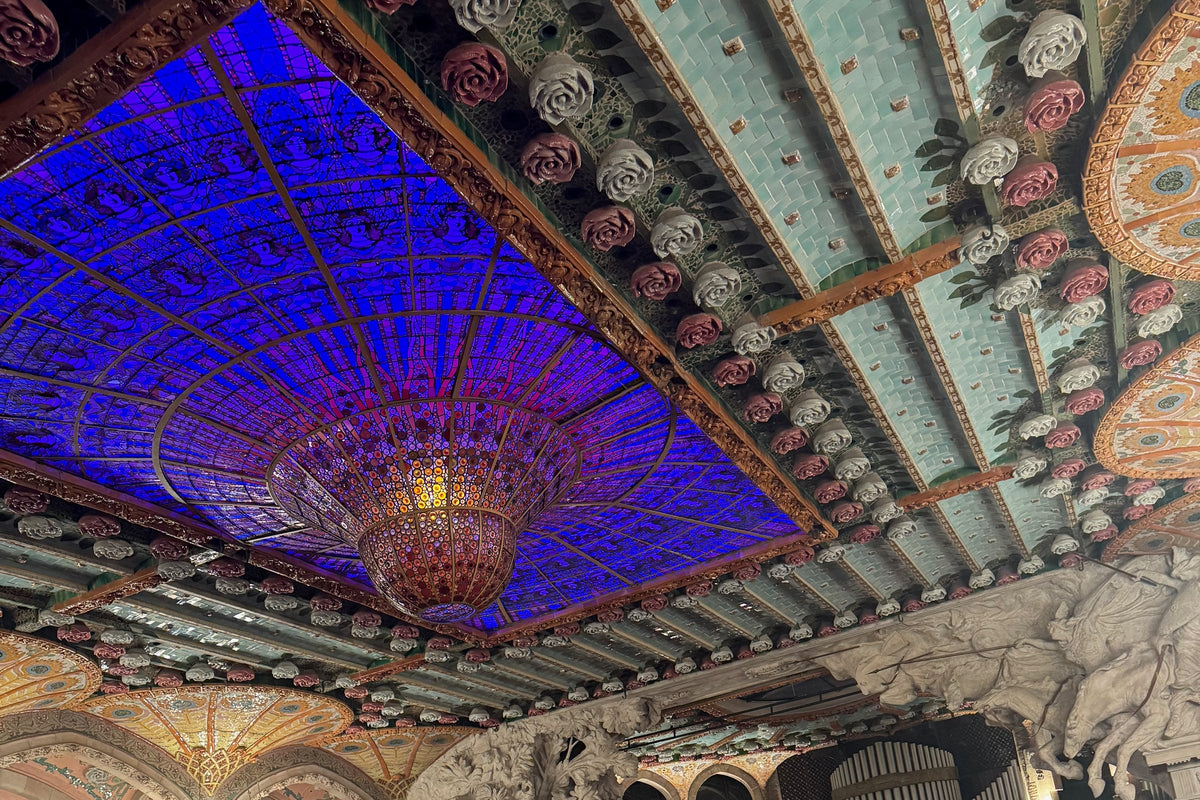 The stained-glass skylight and chandelier above the concert hall of the Palau de la Música Catalana