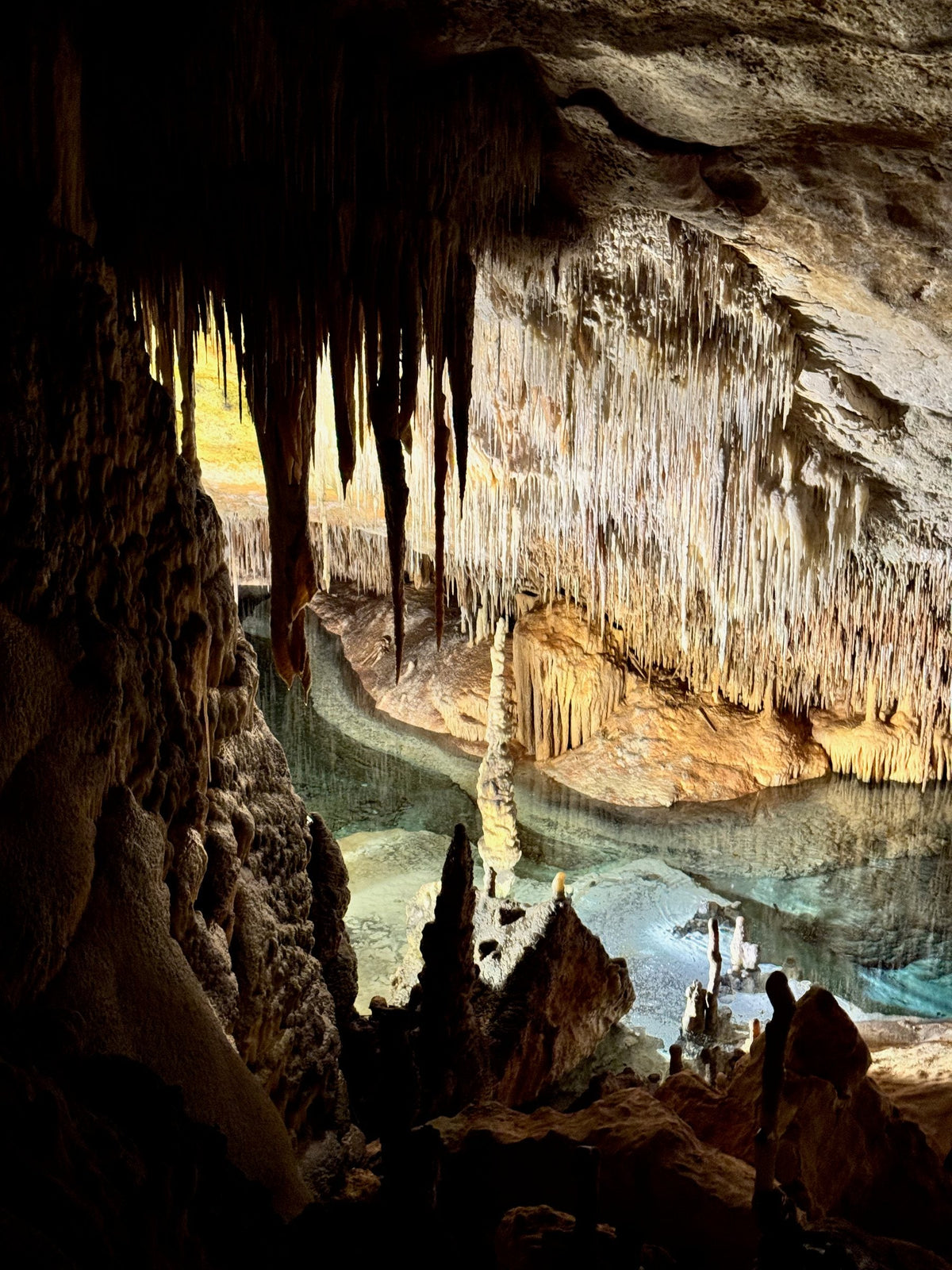 Lake Martel through the stalactites in the Coves del Drach